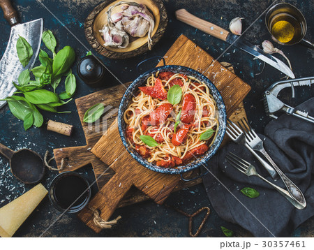 Spaghetti with tomato and basil in plate on wooden 30357461