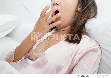 Yawning tired woman on white background 30357577