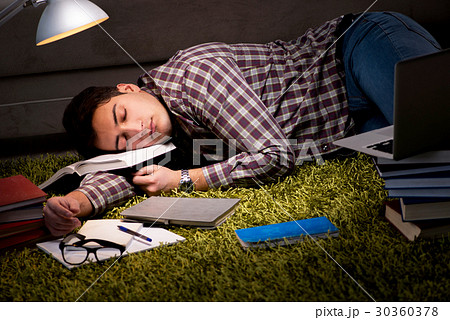 Student reading books preparing for exams Student reading books preparing for exams 30360378