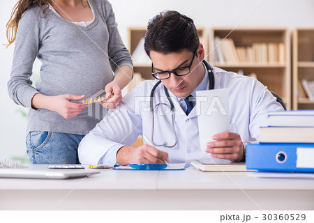 Pregnant woman visiting doctor for consultation 30360529
