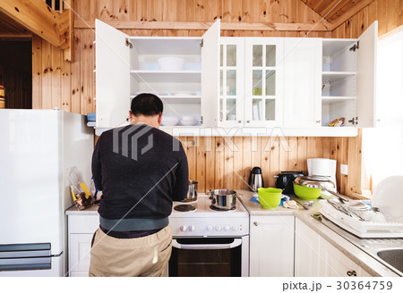 Rear view a man preparing breakfast in kitchen 30364759