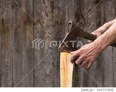 The old axe in the hands of an elderly person  30372409