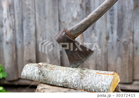 Old axe on a tree stump for chopping firewood. 30372415