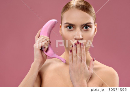 Attractive woman holding banana 30374396
