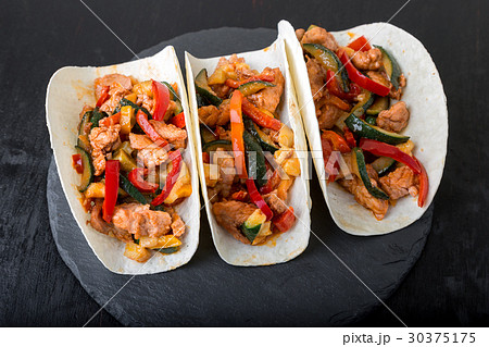 Mexican tacos with pork and vegetables. Mexican tacos with pork and vegetables. 30375175