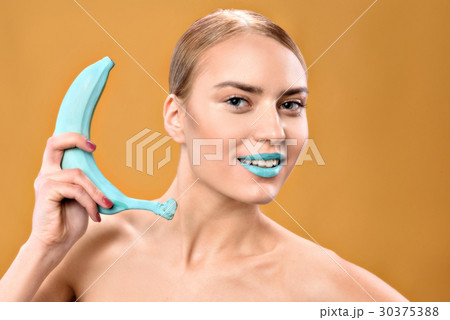 Attractive young woman with blue lips looking at 30375388