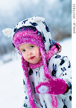 Child in snowy day. Baby girl in white 30375832