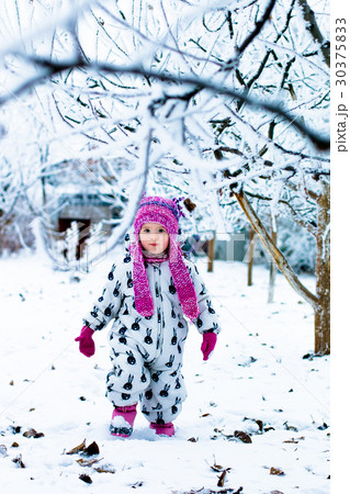 Child in snowy day. Baby girl in white Child in snowy day. Baby girl in white 30375833