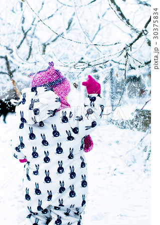 Child in snowy day. Baby girl in white Child in snowy day. Baby girl in white 30375834