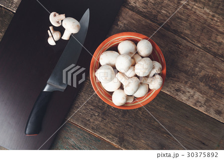 Fresh whole and sliced mushrooms on a cutting 30375892