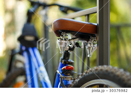 Brown leather comfortable bicycle saddle, closeup 30376982