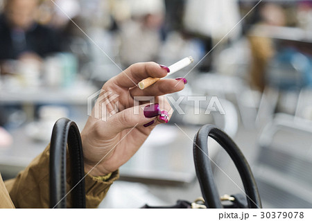 young woman smoking a cigarette 30379078