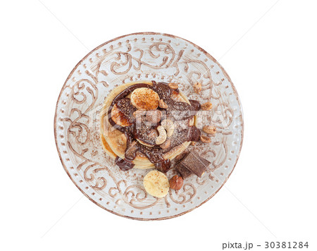 Stack of hot pancakes with nuts, bananas. Isolated 30381284