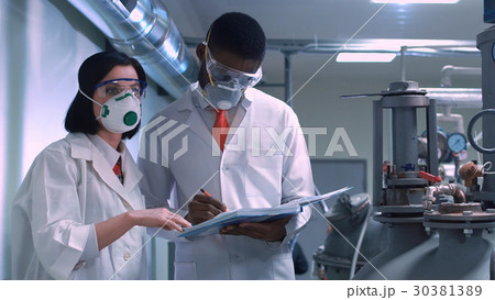 Two scientists with the notepad Two scientists with the notepad 30381389