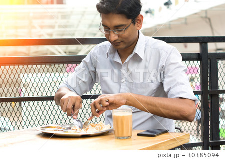 asian business man having roti canai outdoor 30385094