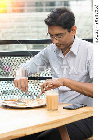 asian business man having roti canai outdoor asian business man having roti canai outdoor 30385097