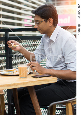 asian business man having roti canai outdoor asian business man having roti canai outdoor 30385102