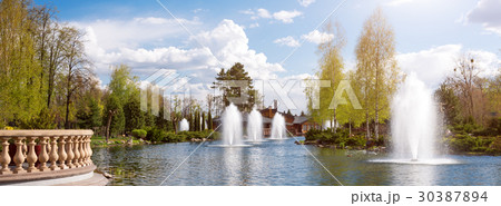 Ornamental gardens with lake, blooming bushes and Ornamental gardens with lake, blooming bushes and 30387894