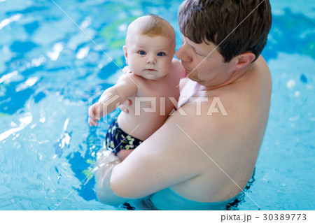 Happy middle-aged father swimming with cute Happy middle-aged father swimming with cute 30389773
