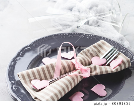 Romantic dinner date plates hearts glasses on gray 30391355