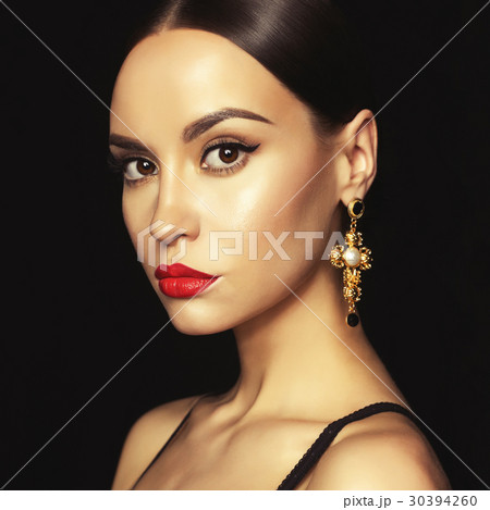 Beautiful lady with earring on black background 30394260