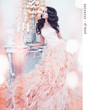 Beautiful lady in gorgeous couture dress in white interior 30394269