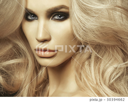 Beautiful blonde woman with smoky eyes makeup Beautiful blonde woman with smoky eyes makeup 30394662