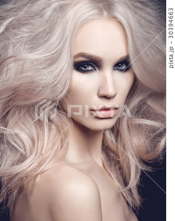 Beautiful blonde woman with smoky eyes makeup Beautiful blonde woman with smoky eyes makeup 30394663
