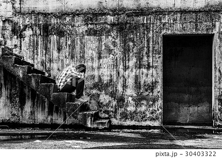 depressed teenager sitting on stair 30403322