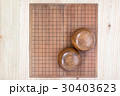 two wooden bowls over empty go game board 30403623