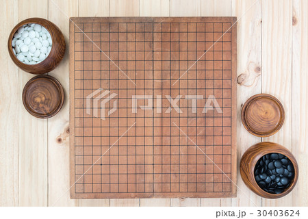 two wooden bowls with empty go game board 30403624
