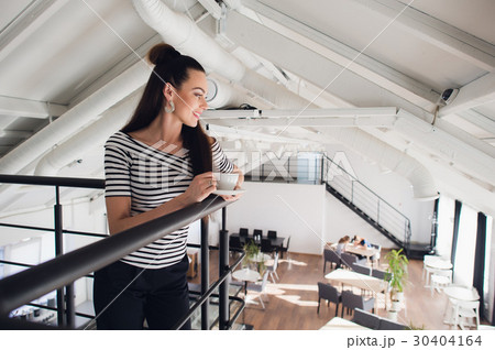Portrait of woman standing with a cup and looking Portrait of woman standing with a cup and looking 30404164
