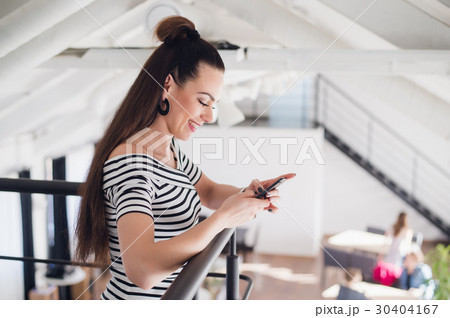 Young beautiful woman with brown hair is standing 30404167