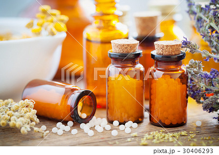 Homeopathic globules, mortar and healing herbs Homeopathic globules, mortar and healing herbs 30406293