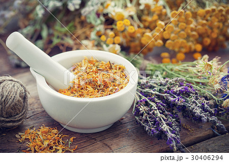 Mortar of dried marigold flowers and healing herbs 30406294