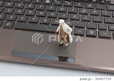 Mini workmen repairing a laptop key board. 30407754