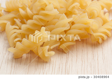 uncooked great italian fusilli on wooden board uncooked great italian fusilli on wooden board 30408964
