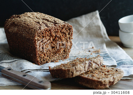Close-up of loaf of whole grain rye bread on a Close-up of loaf of whole grain rye bread on a 30411608
