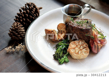 Beef rib eye steak with roasted and vegetables. 30412213