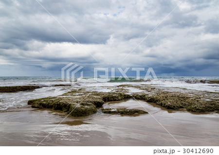 Rocky beach and coming storm Rocky beach and coming storm 30412690