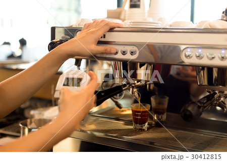 Barista making fresh espresso shot from machine Barista making fresh espresso shot from machine 30412815