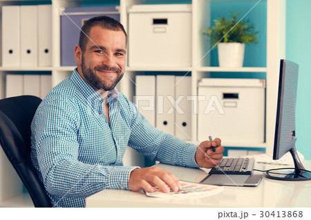 Graphic designer working on digital tablet, toned Graphic designer working on digital tablet, toned 30413868