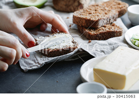 The girl is preparing toast from rye bread and The girl is preparing toast from rye bread and 30415063