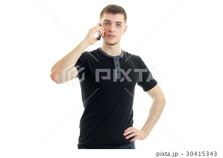 a young guy in a black t-shirt is calling on a 30415343
