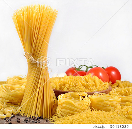 Uncooked Italian pasta, ripe tomatoes branch  30418086