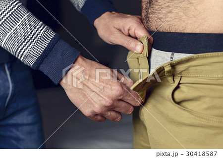 man undressing another man 30418587