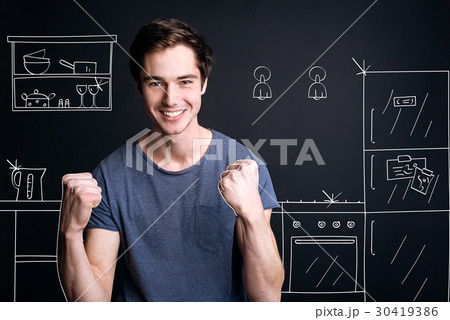 Positive smilign man standing in the kitchen 30419386