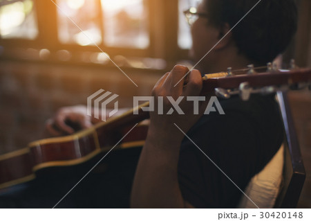 Relaxed man playing guitar Relaxed man playing guitar 30420148