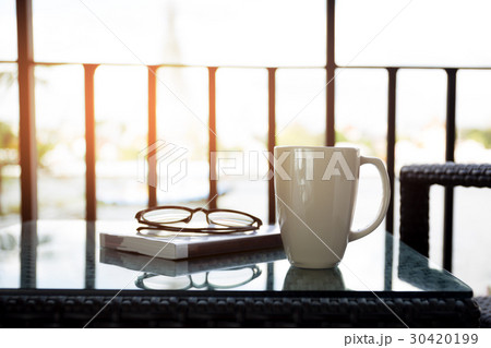 Cup of coffee and reading book with glasses 30420199