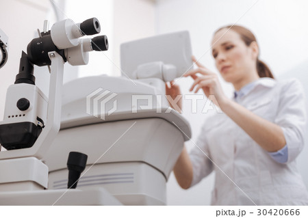 Nice pleasant woman working with eye testing 30420666